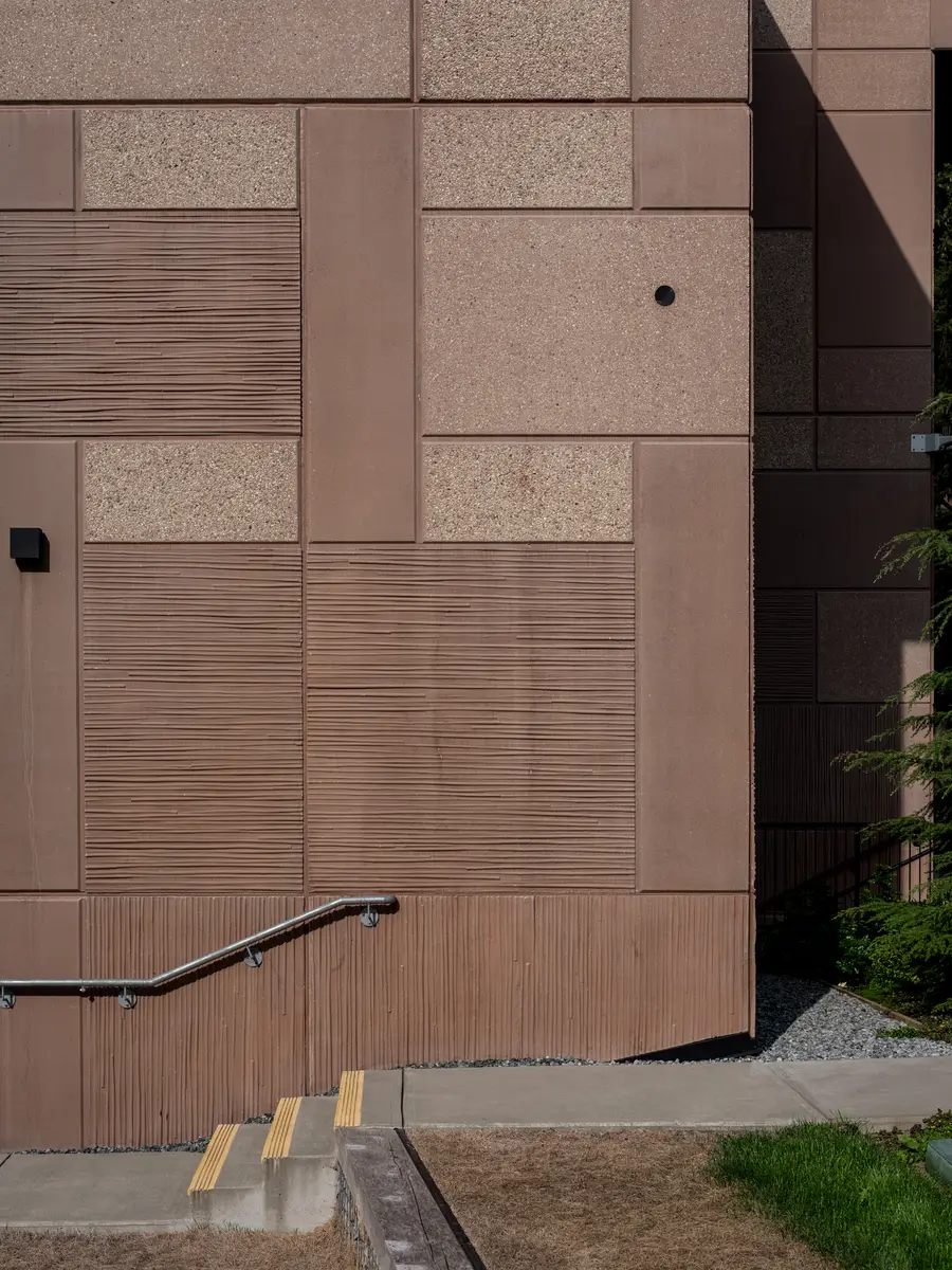 Wood-toned panels on the facade, a handrail at the left