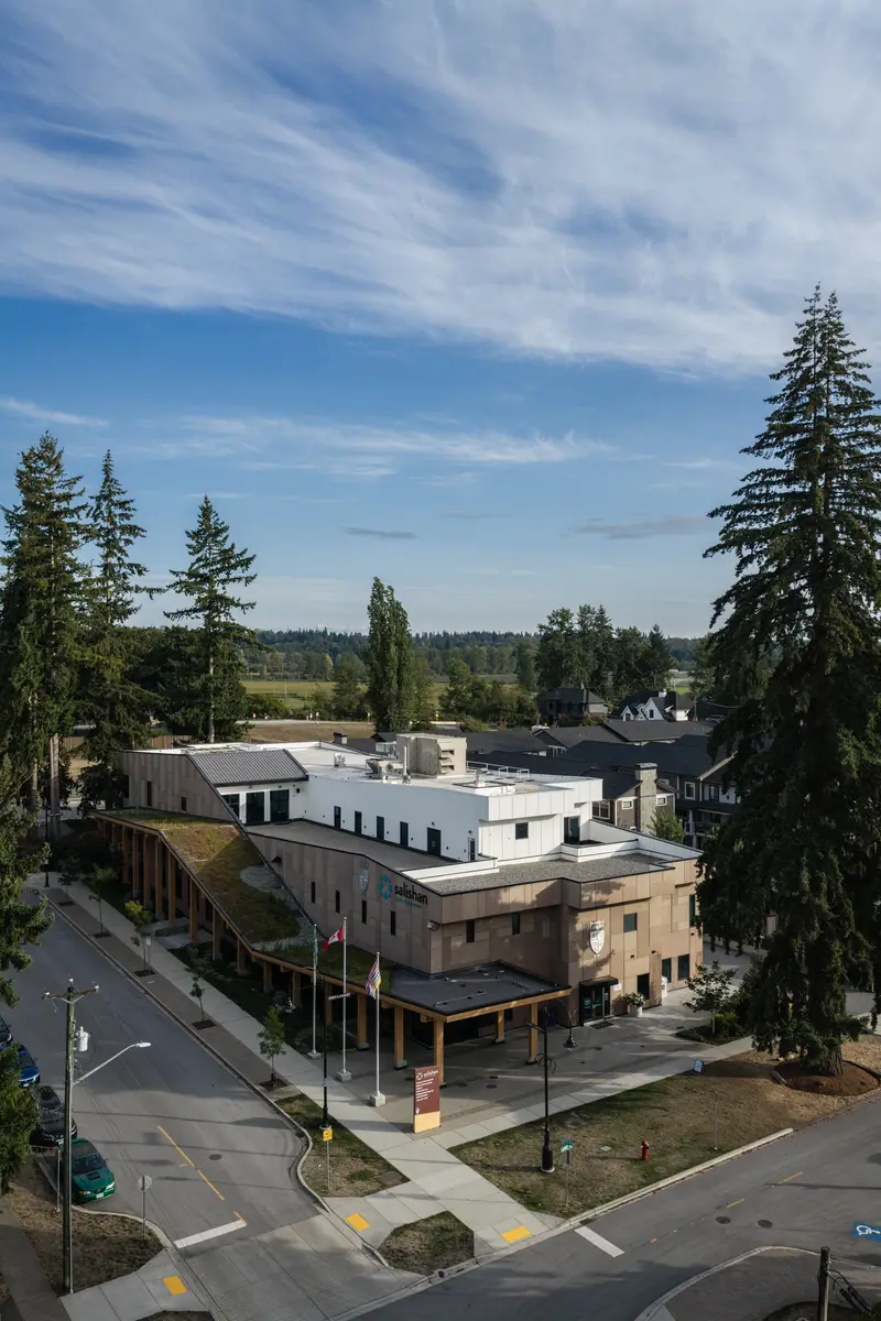 The building from above, the street and evergreens around it