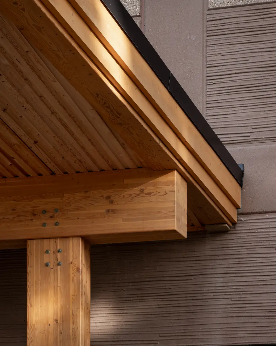 A timber beam meeting a column under the soffit