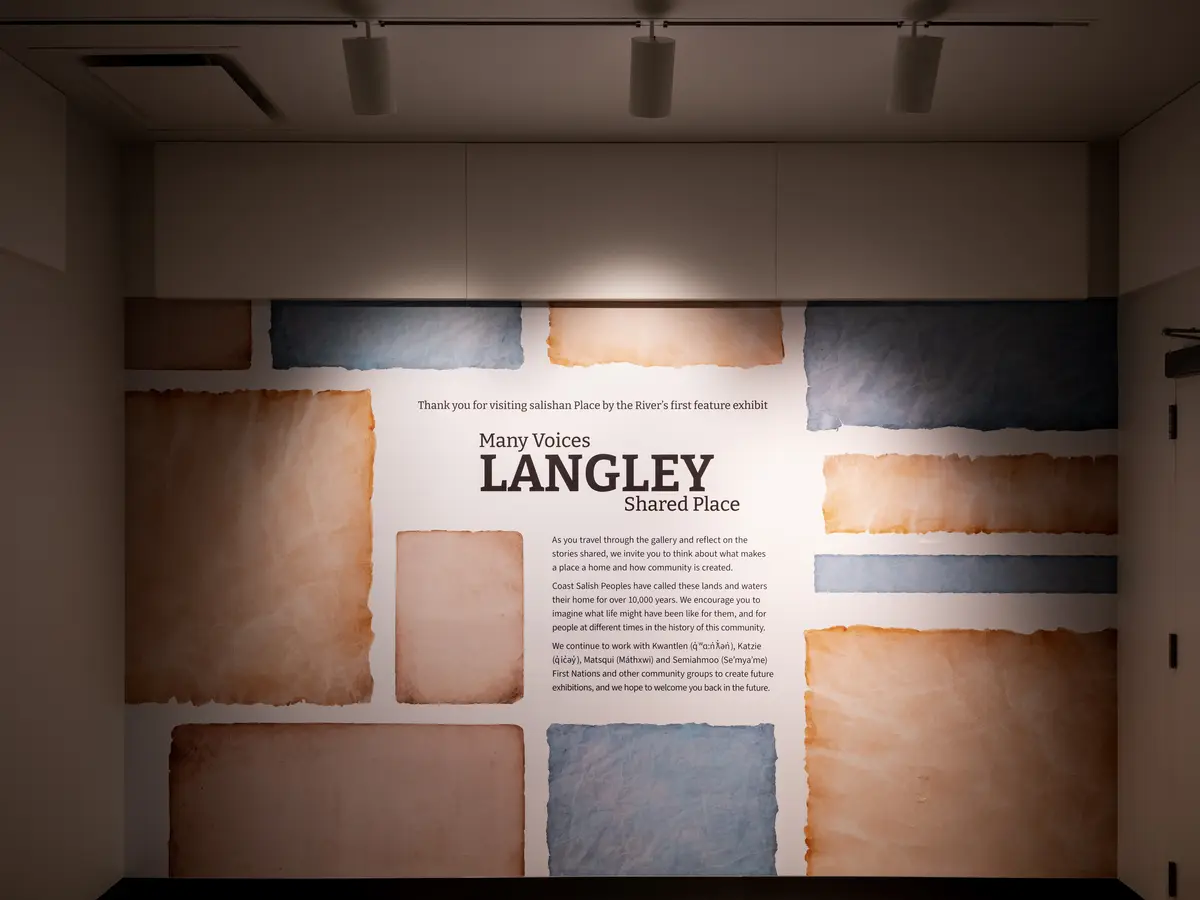 An exhibition wall of textured panels, the word Langley across it