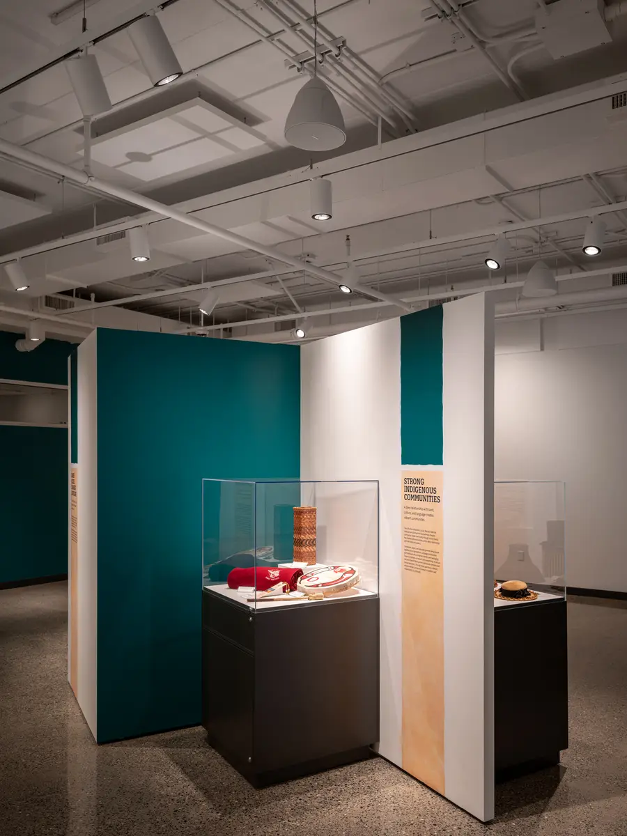 A display case in the gallery, teal and wood panels behind