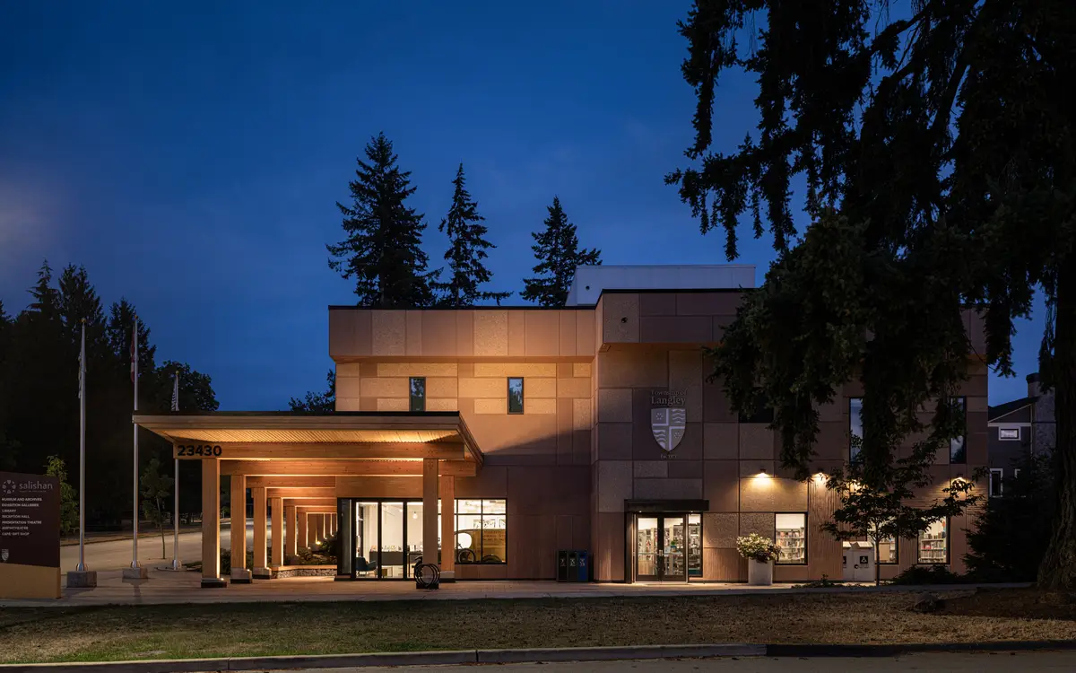 The full elevation at dusk, the canopy and colonnade lit