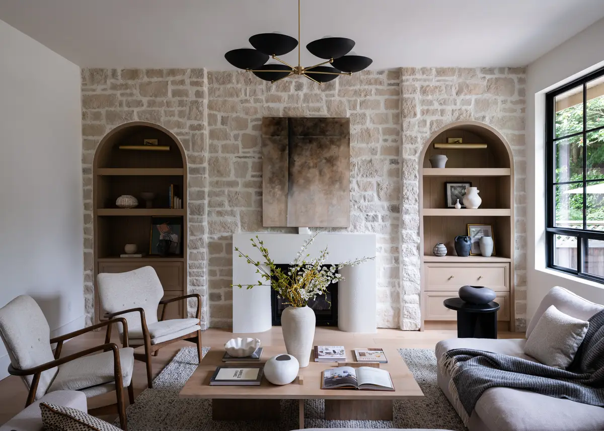 A stone fireplace with arched shelves on either side