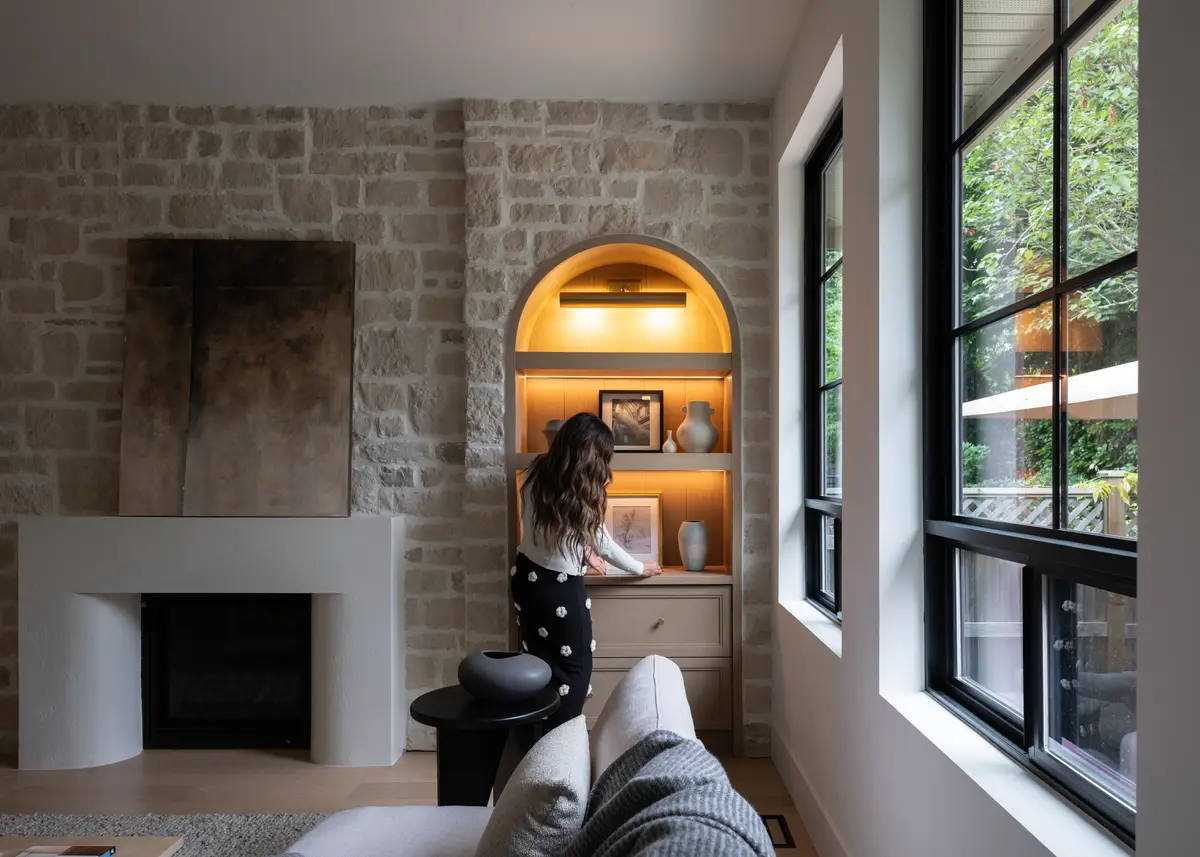 The fireplace and a lit arched niche