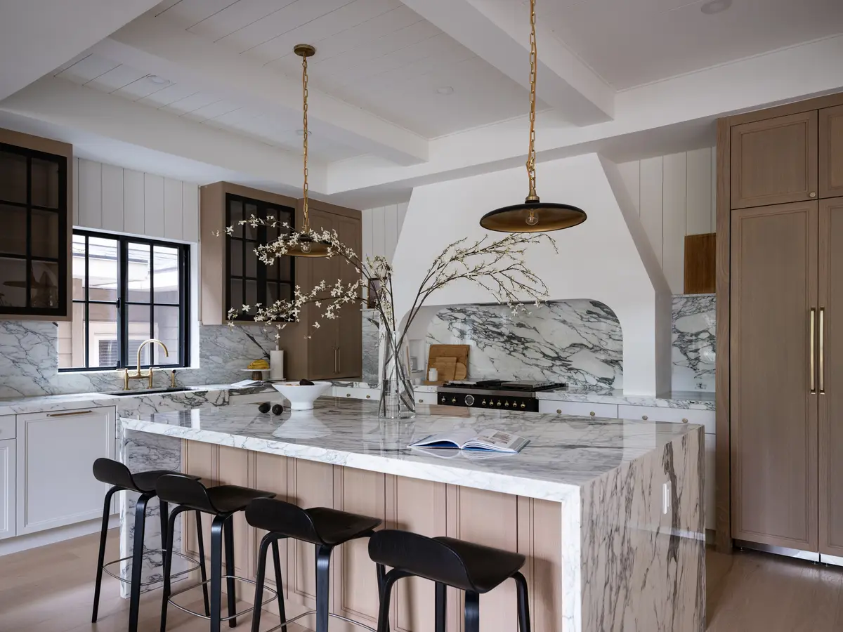 The kitchen island, wood cabinets, and pendants