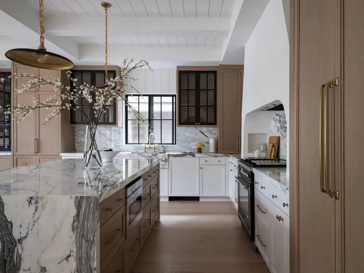 The kitchen, a stone island and tall windows