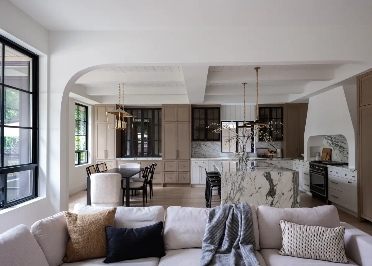 The living room, arches opening to the kitchen